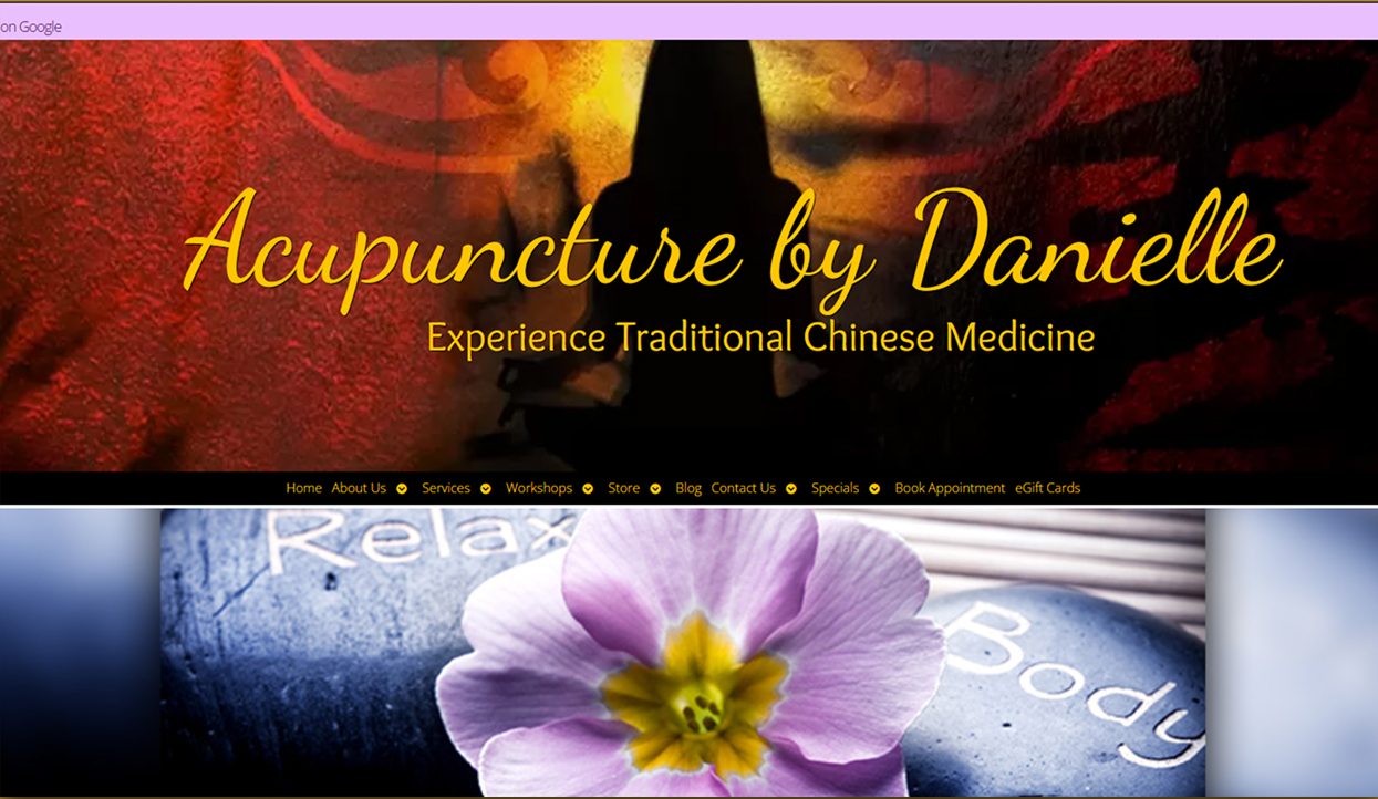 The original homepage, yellow script lettering over a dark red and orange collage, with ten navigation items crammed into a single black strip and stock imagery of pebbles and a flower below